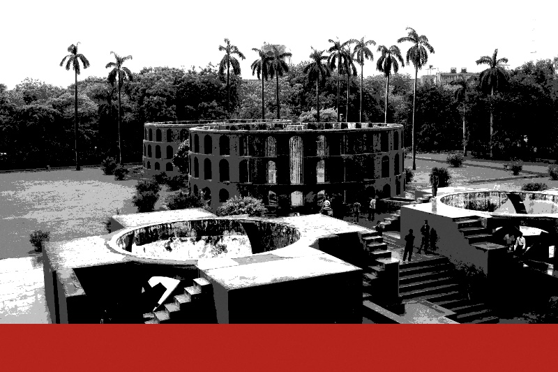 Jantar Mantar in New Delhi, a pair of masonry astronomical instruments with stairs and circular wells, on a lawn under tall palms, with a few visitors on the steps, in near black and white with a flat red band along the foot of the frame