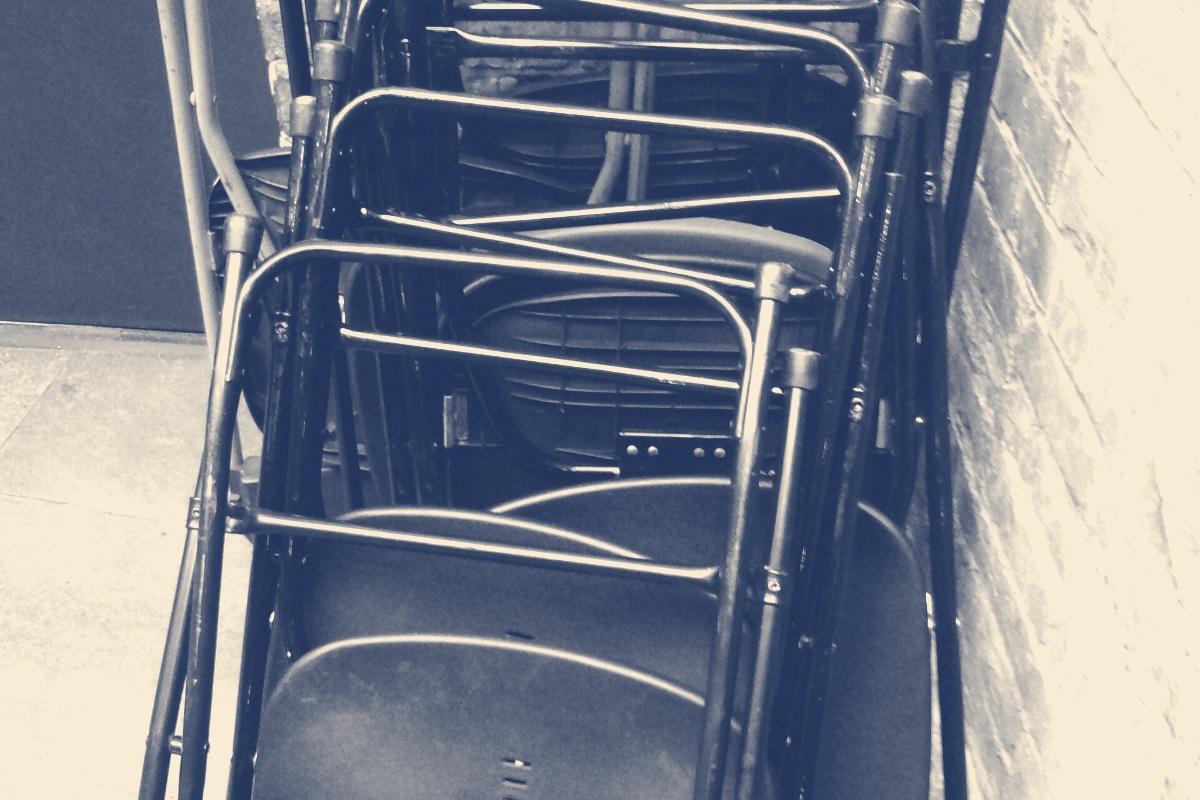 Stacked folding chairs, banded in the house treatment