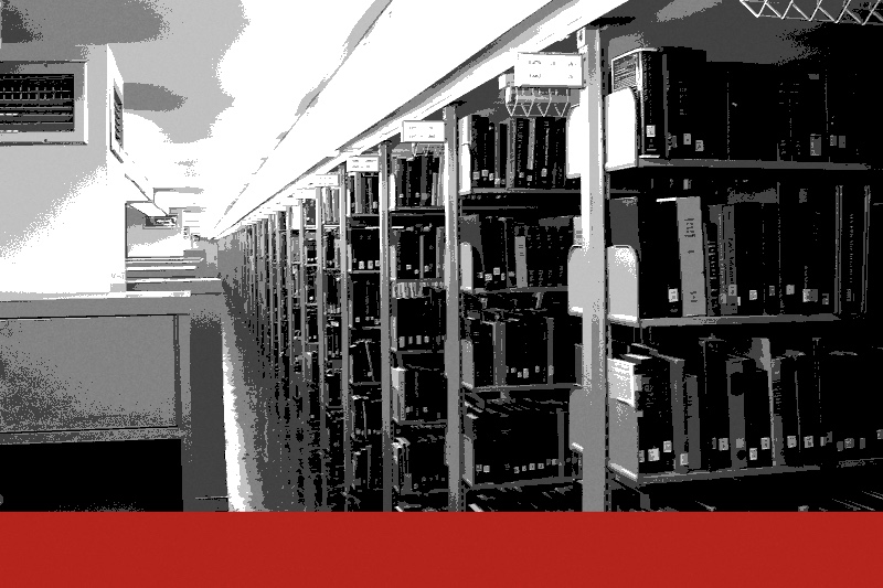A long aisle of library shelving receding into the distance, banded in the house treatment