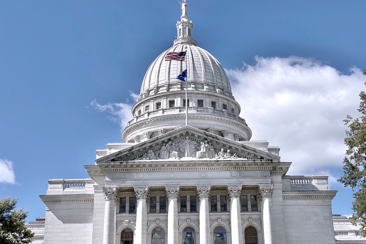 The dome of a state capitol building against a clear sky