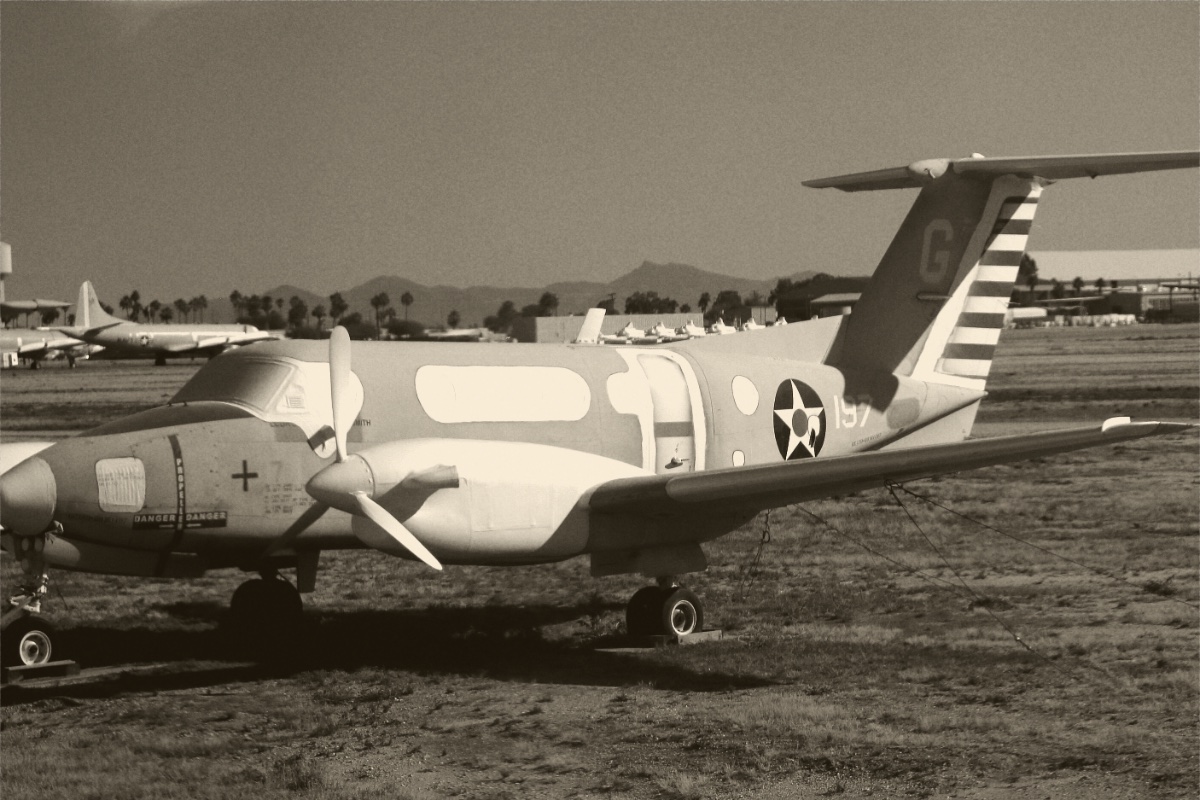 Military aircraft parked in a desert storage yard, in a warm duotone