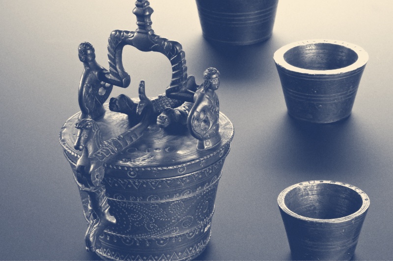 A set of seventeenth century nested brass weights, in a blue duotone