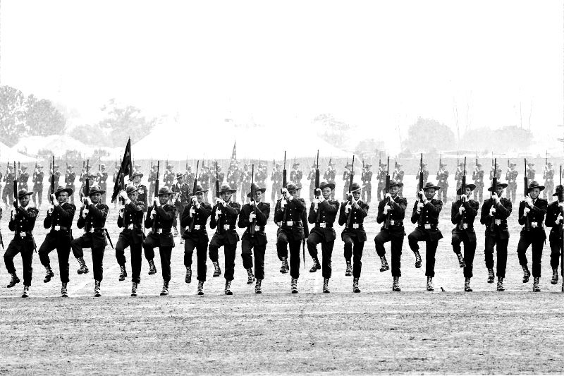 Soldiers march in formation on a field