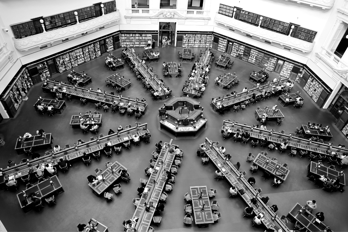 A domed library reading room seen from above with radiating desks, in plain black and white