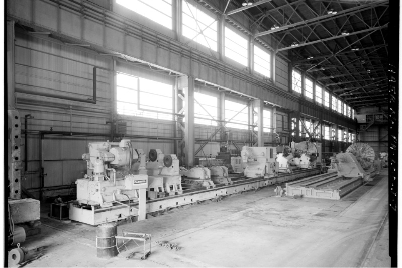 Large lathes on a machine shop floor, in plain black and white