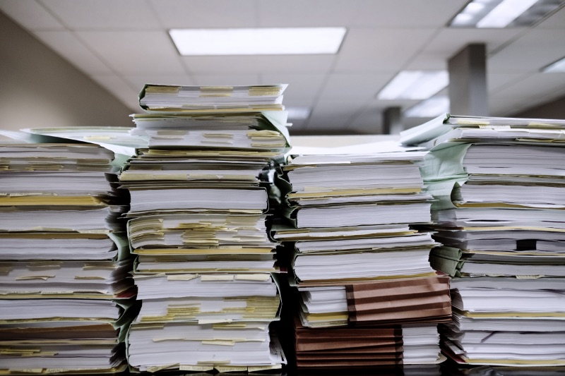 Stacks of paper documents and file folders