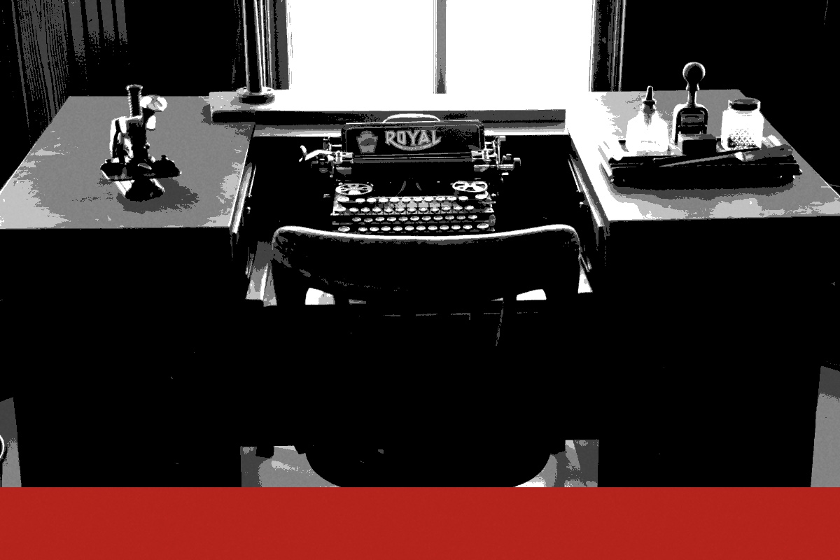 A desk with a typewriter, banded in the house treatment