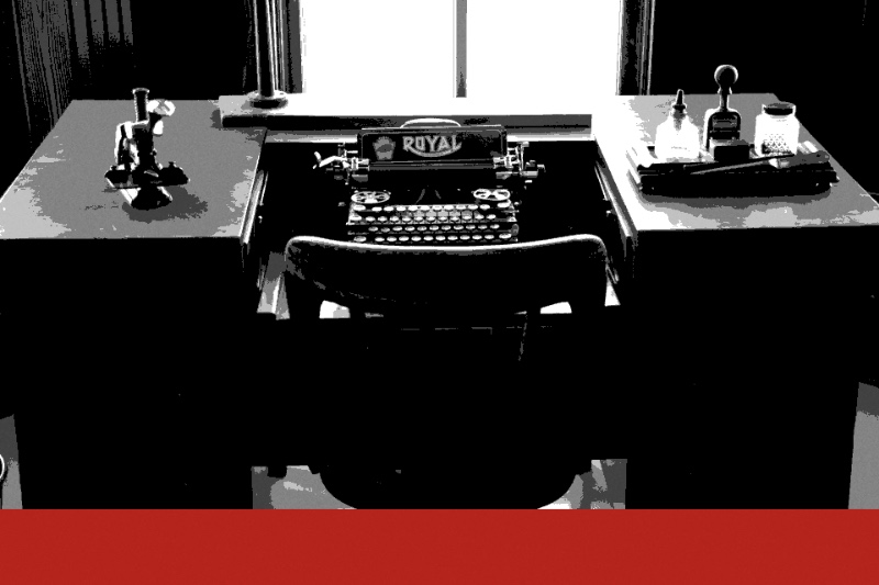 A desk with a typewriter, banded in the house treatment