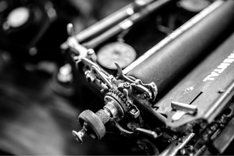 A close view of typewriter type bars and rollers, in plain black and white