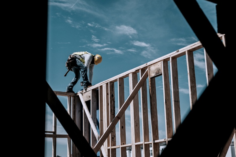 Construction worker in hard hat on building frame