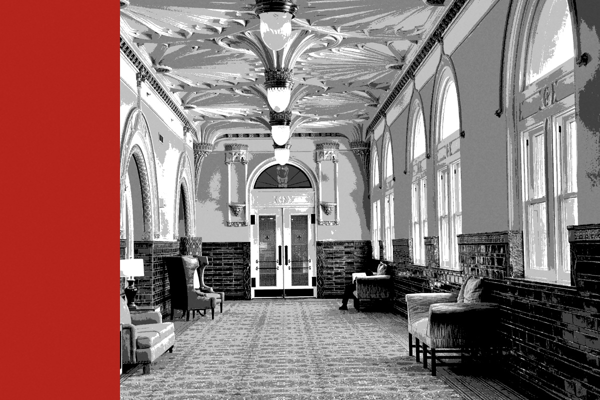 An ornate vaulted public corridor with arched windows, banded in the house treatment