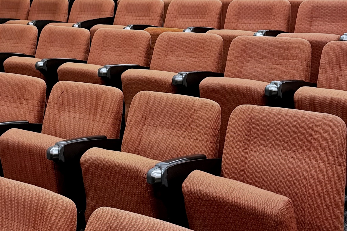 Rows of empty orange theater seats