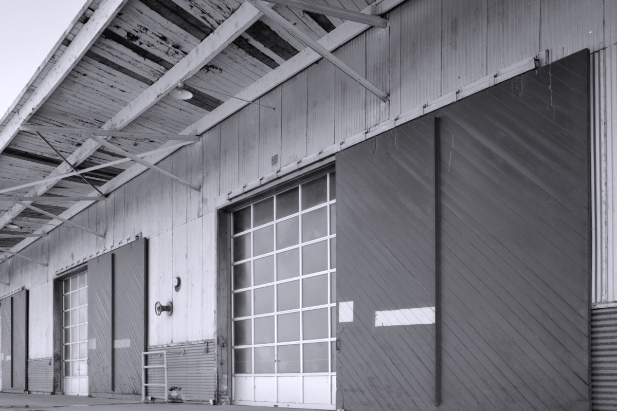 The interior of a large supply shed with loading doors