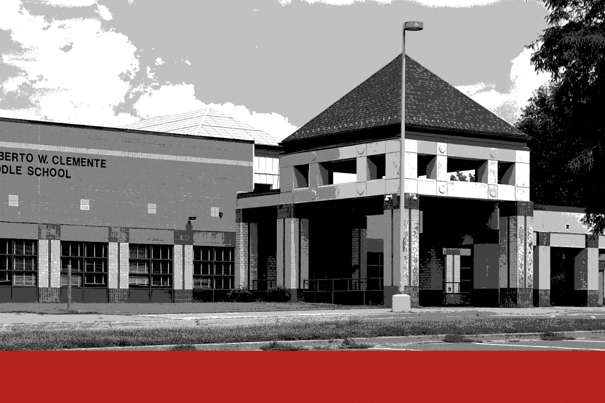 The entrance of Roberto W. Clemente Middle School in Germantown, Maryland, a brick classroom wing with the school&rsquo;s name beside a square entrance pavilion under a pyramid roof, an empty parking lot in front, in black and white with a flat red band along the foot