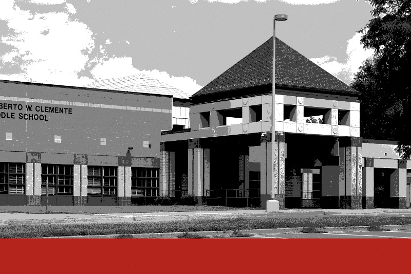 The entrance of Roberto W. Clemente Middle School in Germantown, Maryland, a brick classroom wing with the school’s name beside a square entrance pavilion under a pyramid roof, an empty parking lot in front, in black and white with a flat red band along the foot