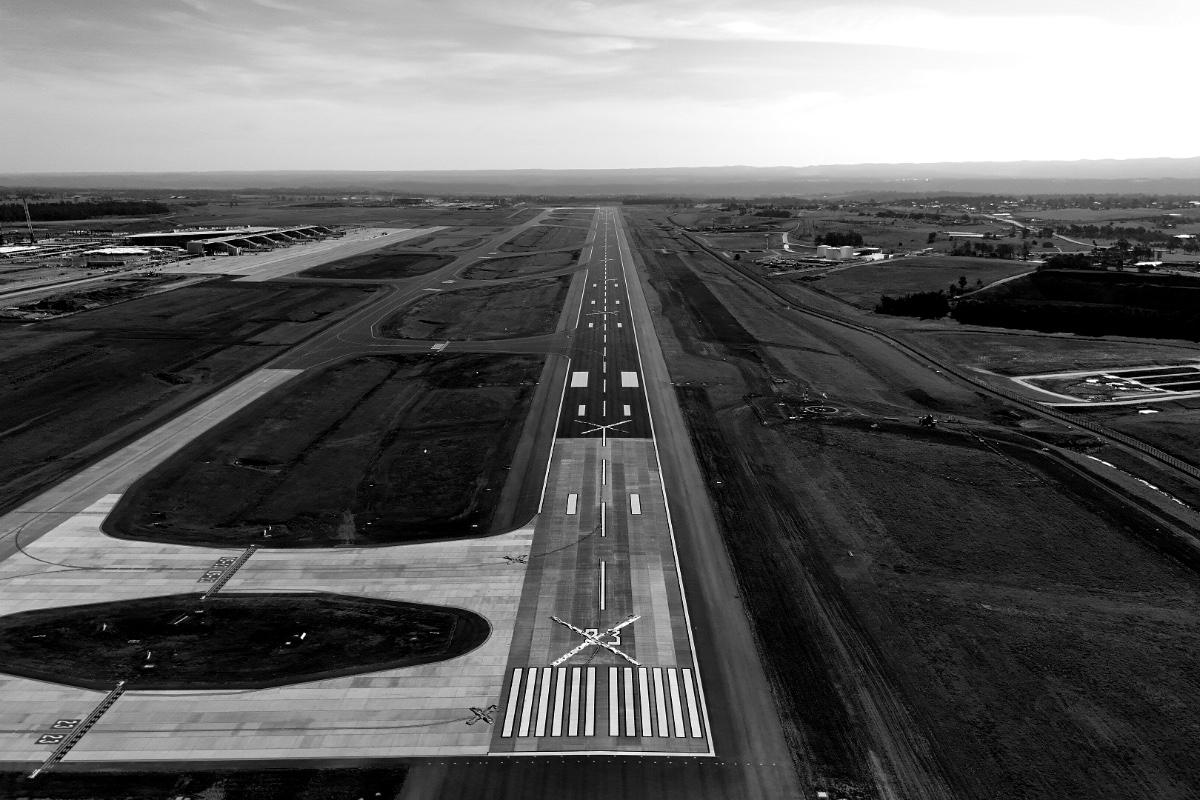 An aerial view along an airport runway, in plain black and white