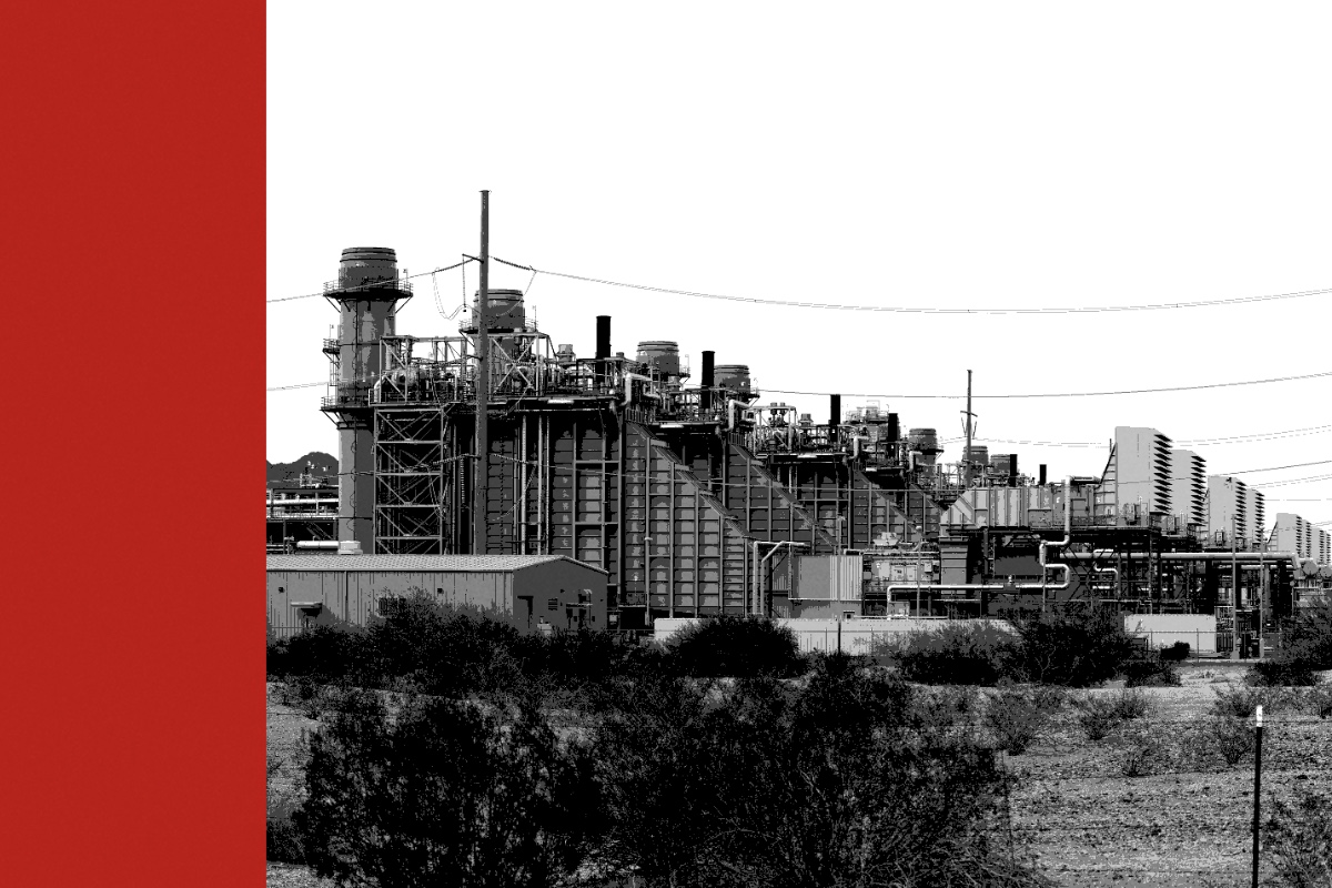 A natural gas power station with exhaust stacks on a flat desert landscape, with a red bar along the left edge