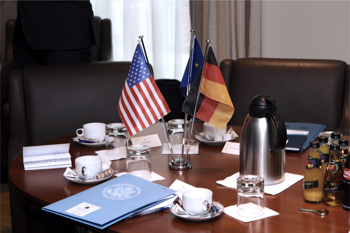 Small national flags on a meeting table set for two delegations