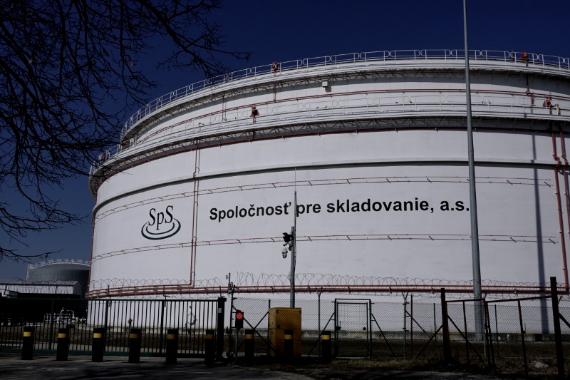 Large industrial storage tanks under a clear blue sky