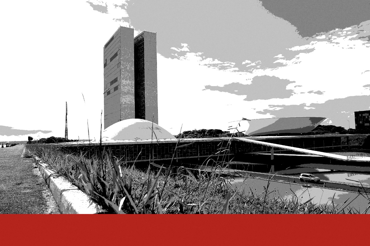 The National Congress in Brasilia seen from a grass verge beside a road, two tall office towers above a low white dome and an upturned bowl, with a reflecting pool to the right, in near black and white with a flat red band along the foot of the frame