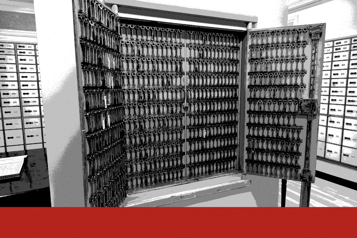 A cabinet of safe deposit keys in a bank vault room, banded in the house treatment