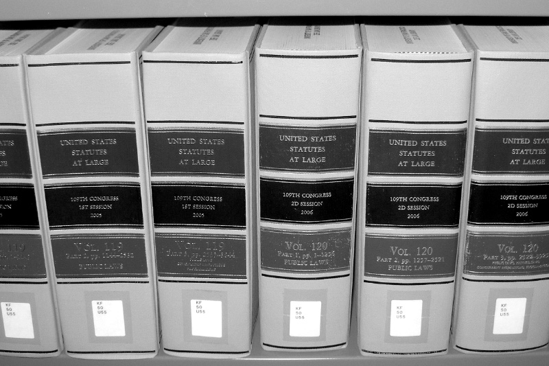 Bound volumes of the United States Statutes at Large on a library shelf