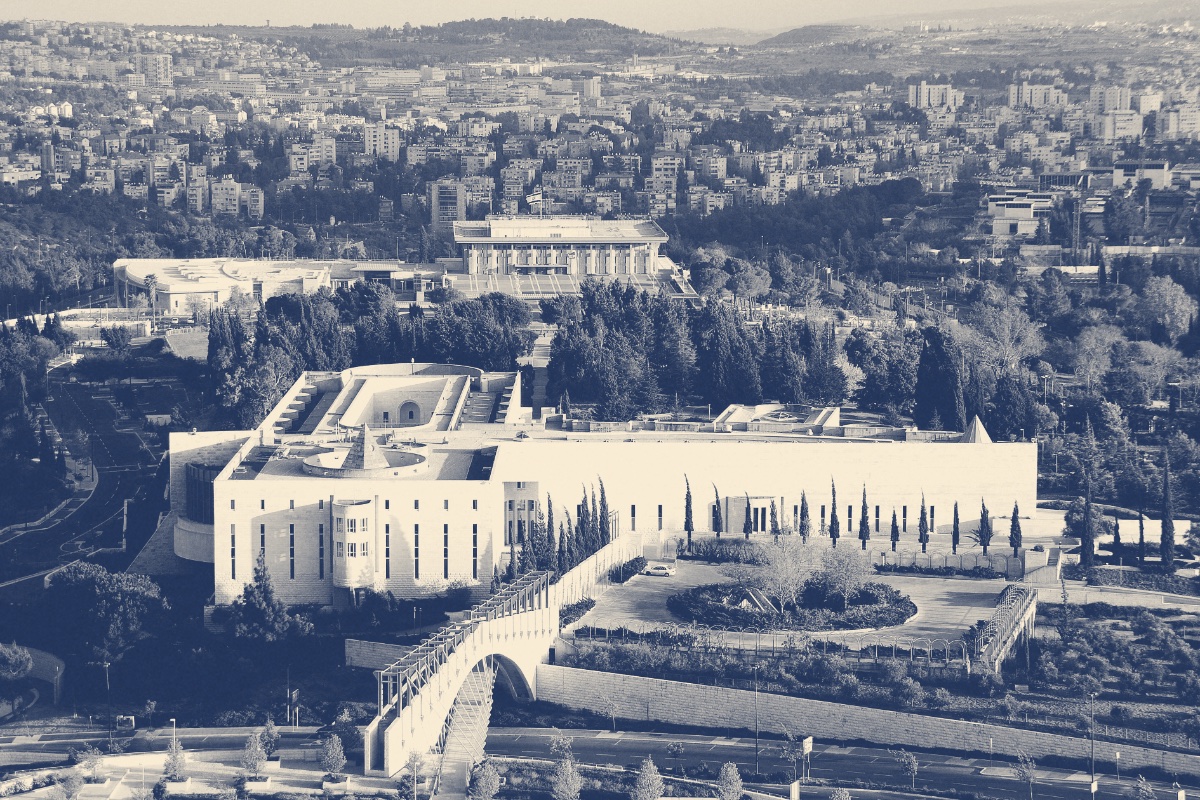 The Supreme Court of Israel in Jerusalem seen from above among cypress trees, the Knesset on the rise behind it, in a slate and bone duotone