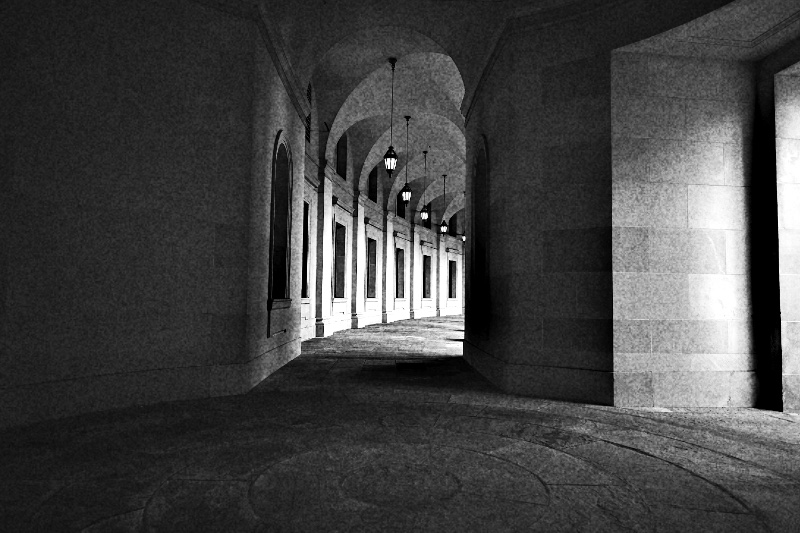 A vaulted stone arcade lit by hanging lanterns, receding into shadow with nobody in it, in high contrast black and white with coarse grain
