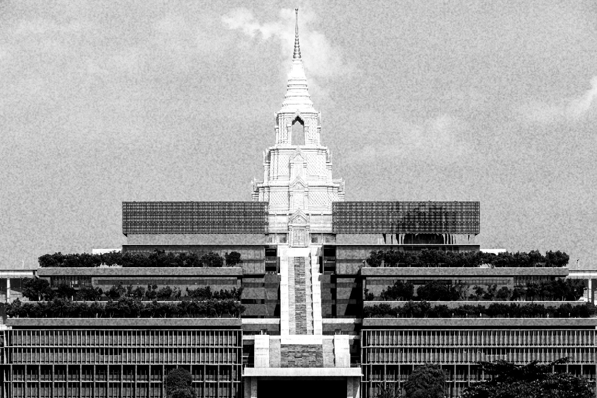 The Sappaya-Sapasathan parliament building in Bangkok, tiers of terraces and glass rising to a tall spired tower at its centre, in high contrast black and white with coarse grain