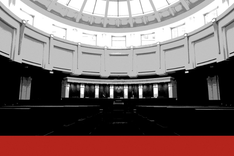 The Colorado Supreme Court courtroom in Denver under its glass dome, the bench backed by curtains and the state seal, in near black and white with a flat red band along the foot of the frame