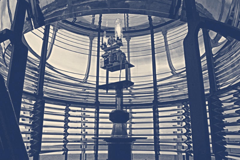The interior of a Fresnel lighthouse lens, in a blue duotone